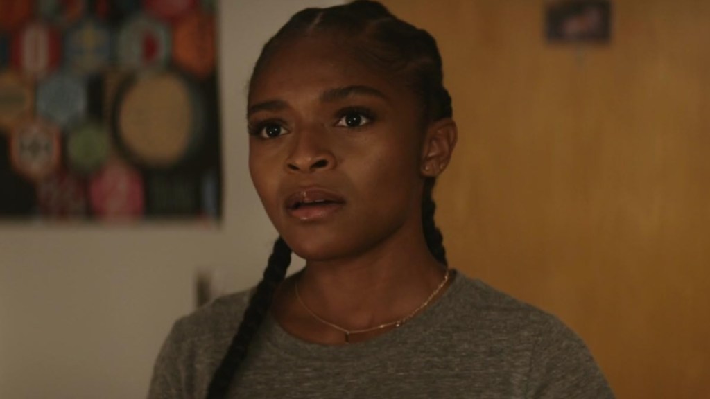 Dominique Thorne stands and stares at something.