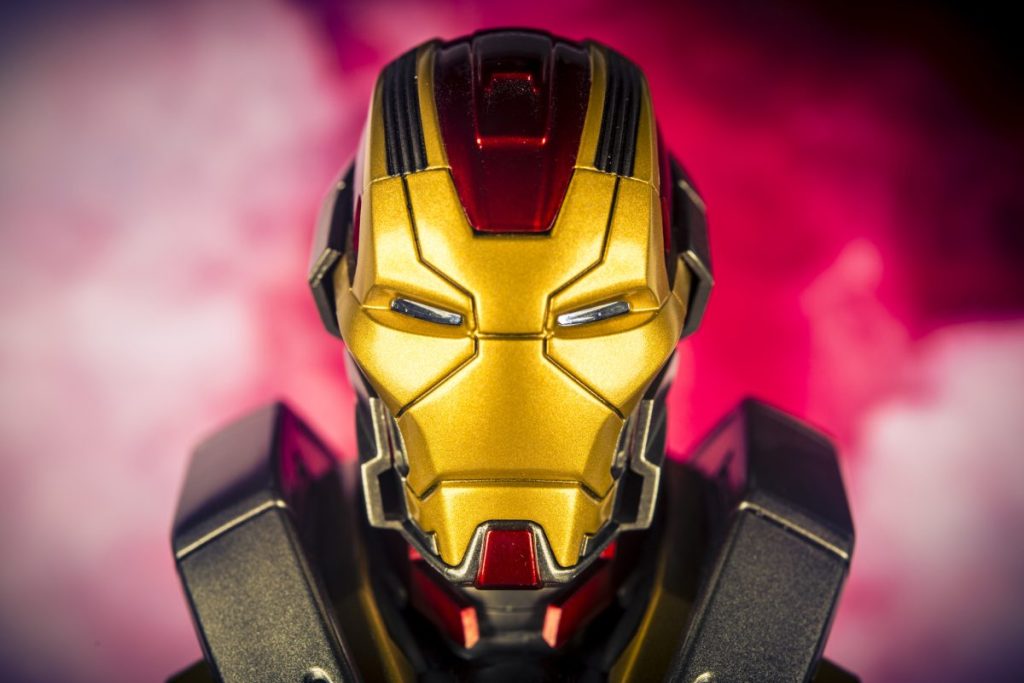 A headshot of Iron Man with red smoke in the background.